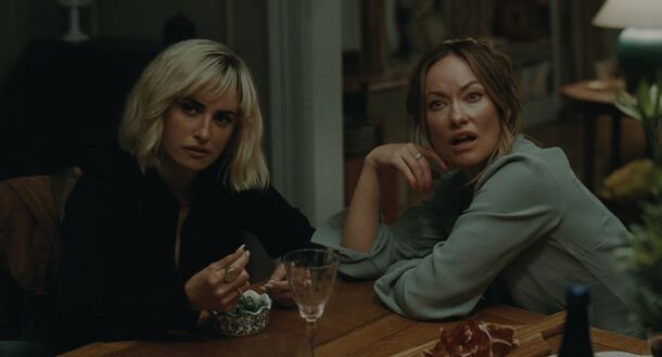 Two women talking over drinks in The Invite