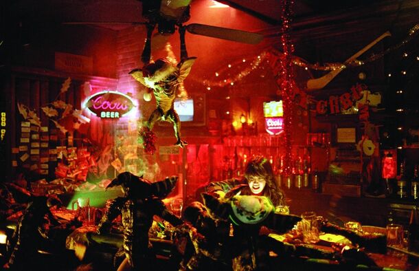 Gremlins running riot through a neon-lit bar in the 1984 original