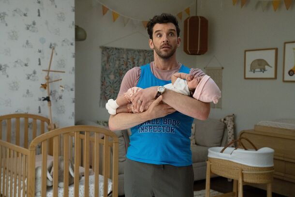 Jimmy holding a baby in the nursery in Shrinking