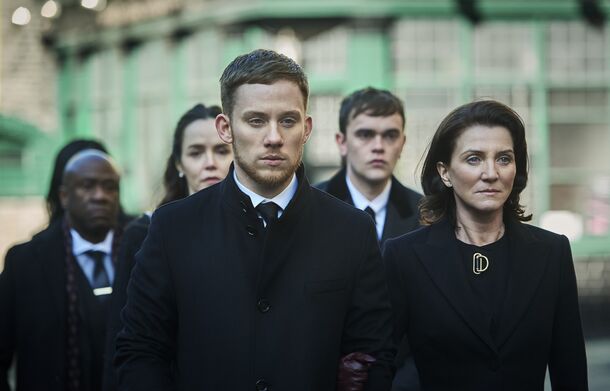 Michelle Fairley as Marian Wallace with her family in Gangs of London (2020). In the series 3 finale, a phone left by Zeek shows her who ordered her son Sean's death