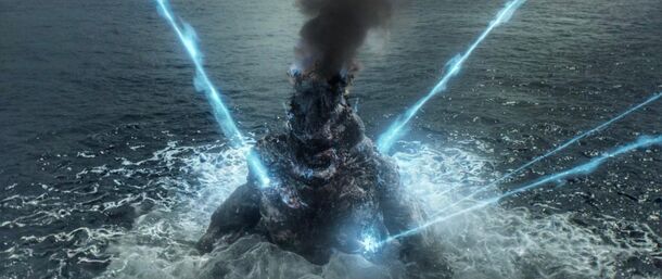 Godzilla firing its atomic breath at sea in Godzilla Minus One (2023). The film ends with Godzilla's flesh regenerating at the bottom of the ocean