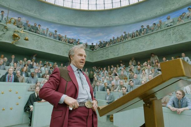 Tom Cruise as Digger Rockwell at the lectern in Digger (2026). The film opened on October 2 and had $41 million worldwide by mid-October