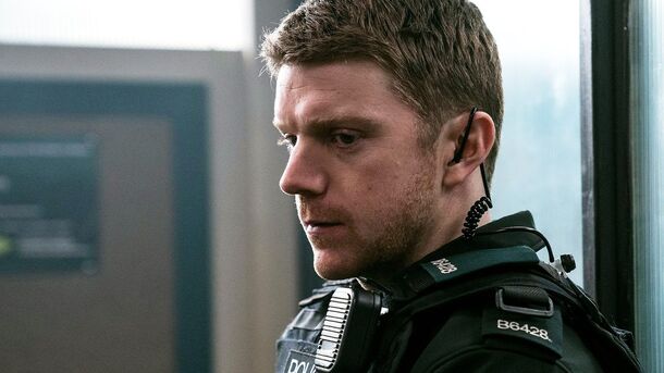 A Blue Lights response officer on patrol in Belfast body armour, radio at the shoulder