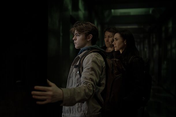A Jason reaches out to his family in a darkened corridor in Apple TV+ thriller Dark Matter