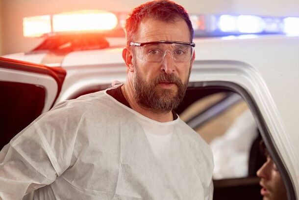Noah Wyle as Dr. Robby outside the ambulance bay in The Pitt