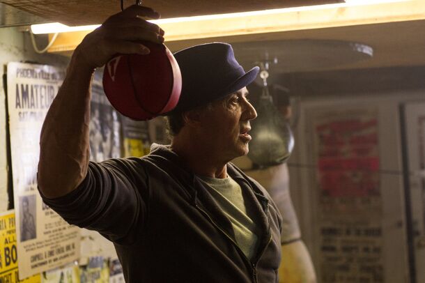 Sylvester Stallone working the speed bag in the gym in Creed