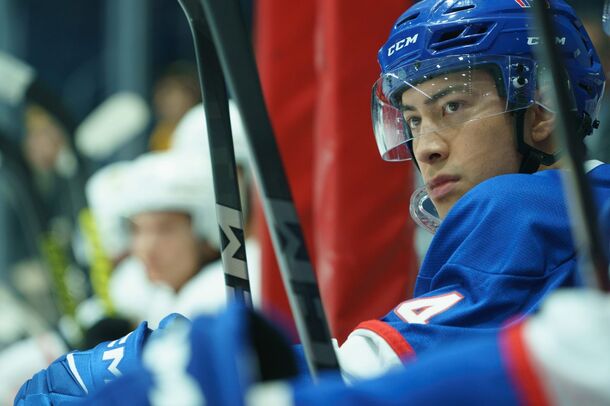 A player watching from the bench in Heated Rivalry