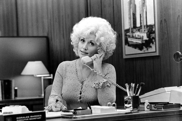 Dolly Parton at her desk in 9 to 5