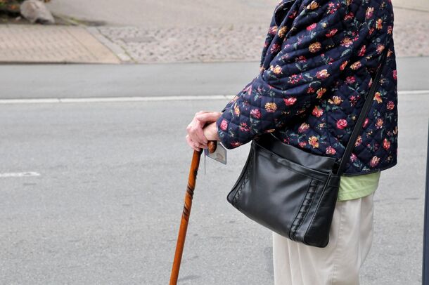 A retiree out walking while waiting on the month's payment
