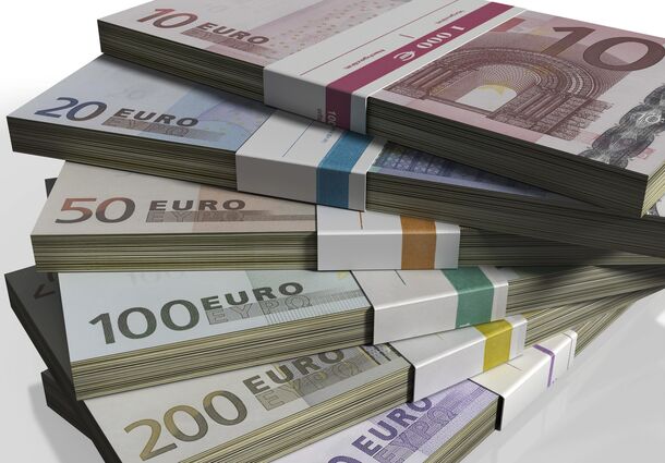 Stacks of euro notes — where a wage floor actually stretches further