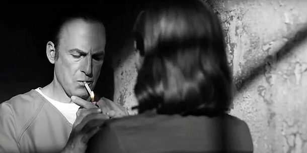 Bob Odenkirk as Jimmy McGill shares a cigarette with Kim in Saul Gone, the finale of Better Call Saul (2015). In the black-and-white episode, only the flame and the burning tip glow in color