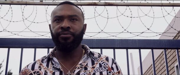 A man by a barbed-wire fence in Kings of Jo'burg (2020), Netflix's South African crime drama. The season 3 finale ends with a rocket attack on the villa where Veronica lives
