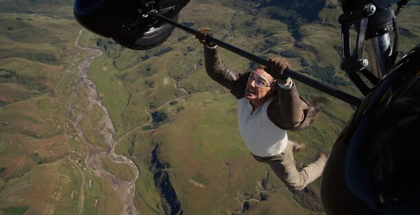 Tom Cruise hanging from a biplane in Mission: Impossible – The Final Reckoning (2025). The film made $598.8 million worldwide on a budget reported at $300 million to $400 million