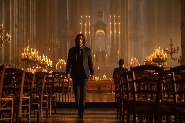 Keanu Reeves as John Wick in a candlelit church in John Wick: Chapter 4 (2023). The $100 million film made $447.3 million worldwide, the most in the franchise